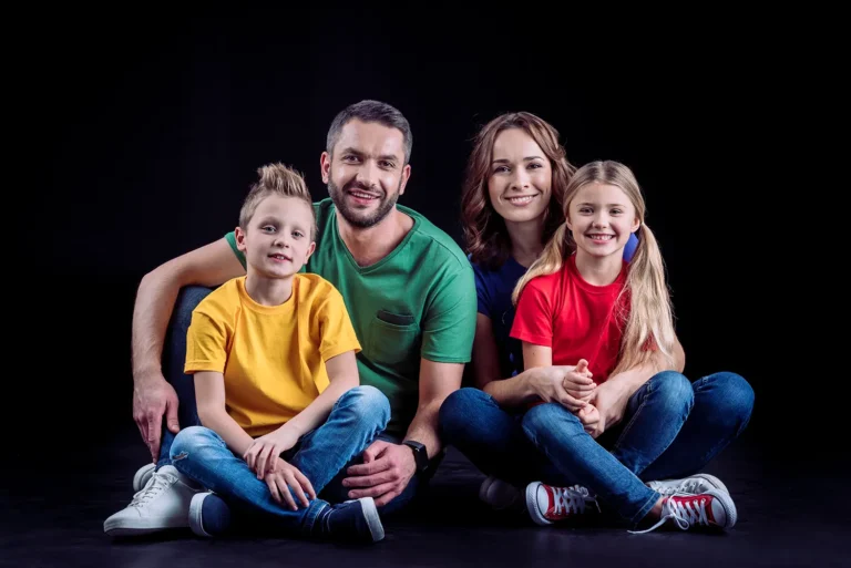 happy-family-in-colored-t-shirts-sitting-together-2023-11-27-04-58-51-utc