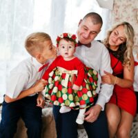 Caucasian family posed in vintage studio room