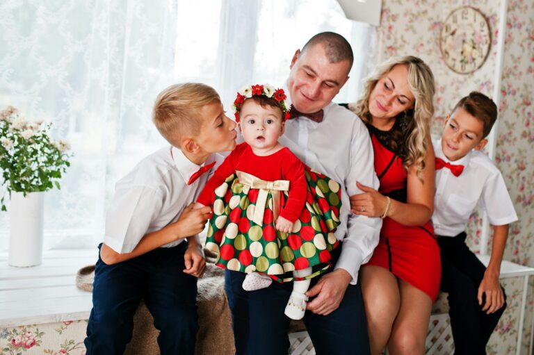 Caucasian family posed in vintage studio room