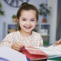 Portrait of smiling child studying at home